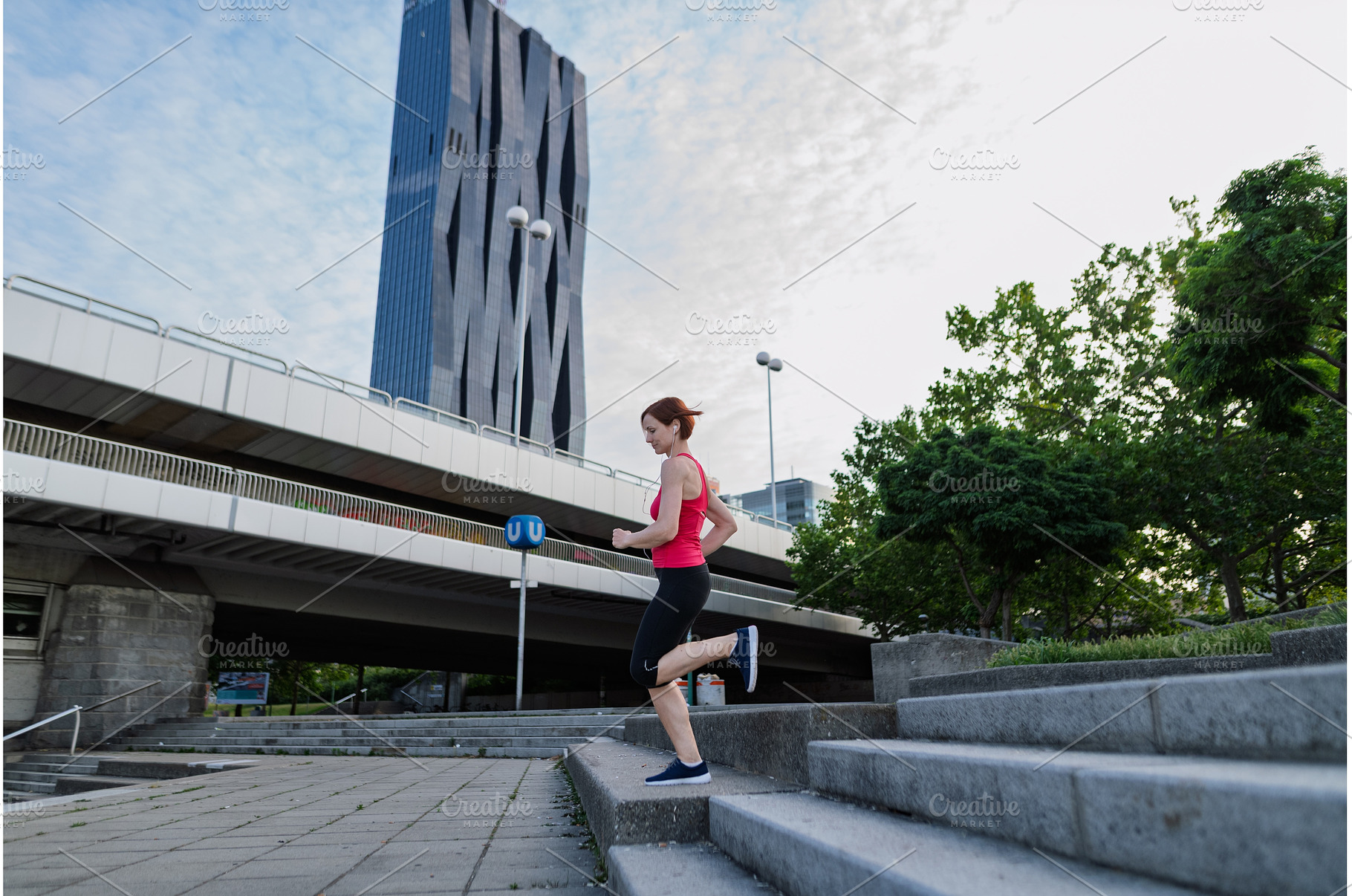 Sporty woman running down the stairs, a Person Photo by HalfPoint
