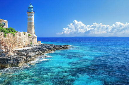 Chania lighthouse stands tall agains, a Photo by Iftikhar Alam