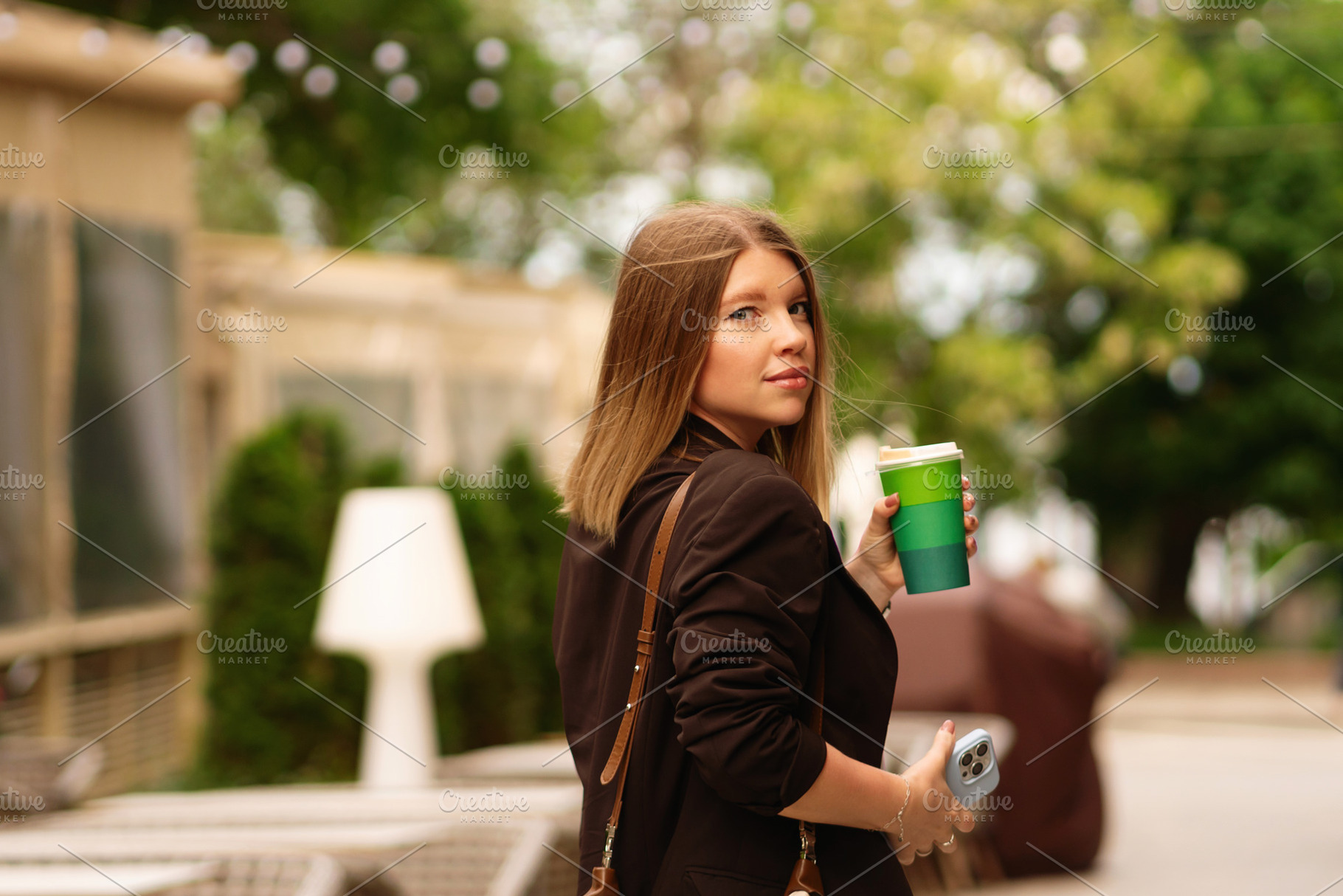 Woman with handbag holding coffee, a Person Photo by Elena Vagengeim