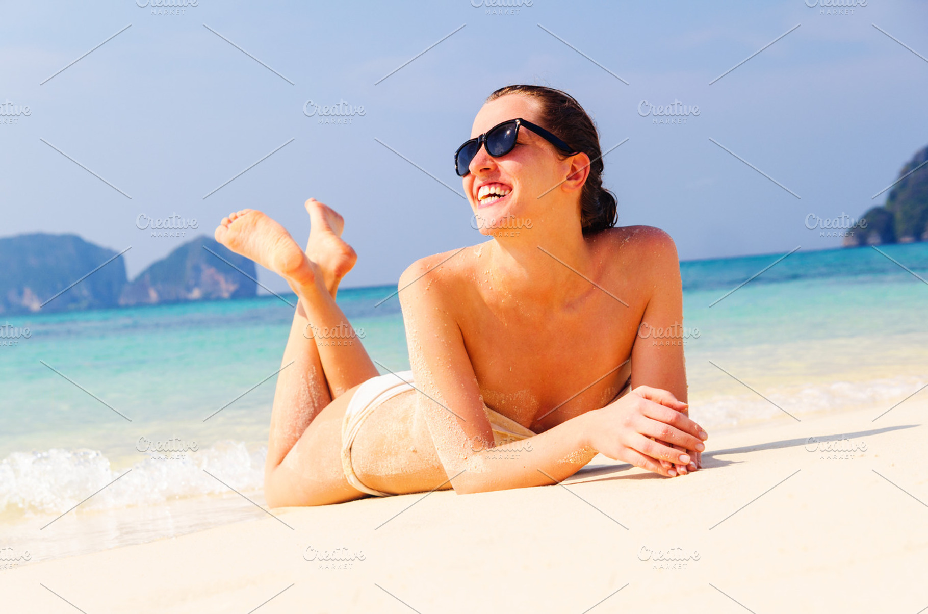 Woman is lying on beach stock photo containing body and leisure, a Person Photo by sergeypeterman