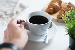Hand Holding Cup of Black Coffee During Relaxing Breakfast at Home, a Food & Drink Photo by etorres69