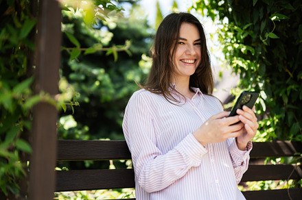 Young freelancer woman in shirt sit on bench in summer park outd, a Person Photo by AS photostudio