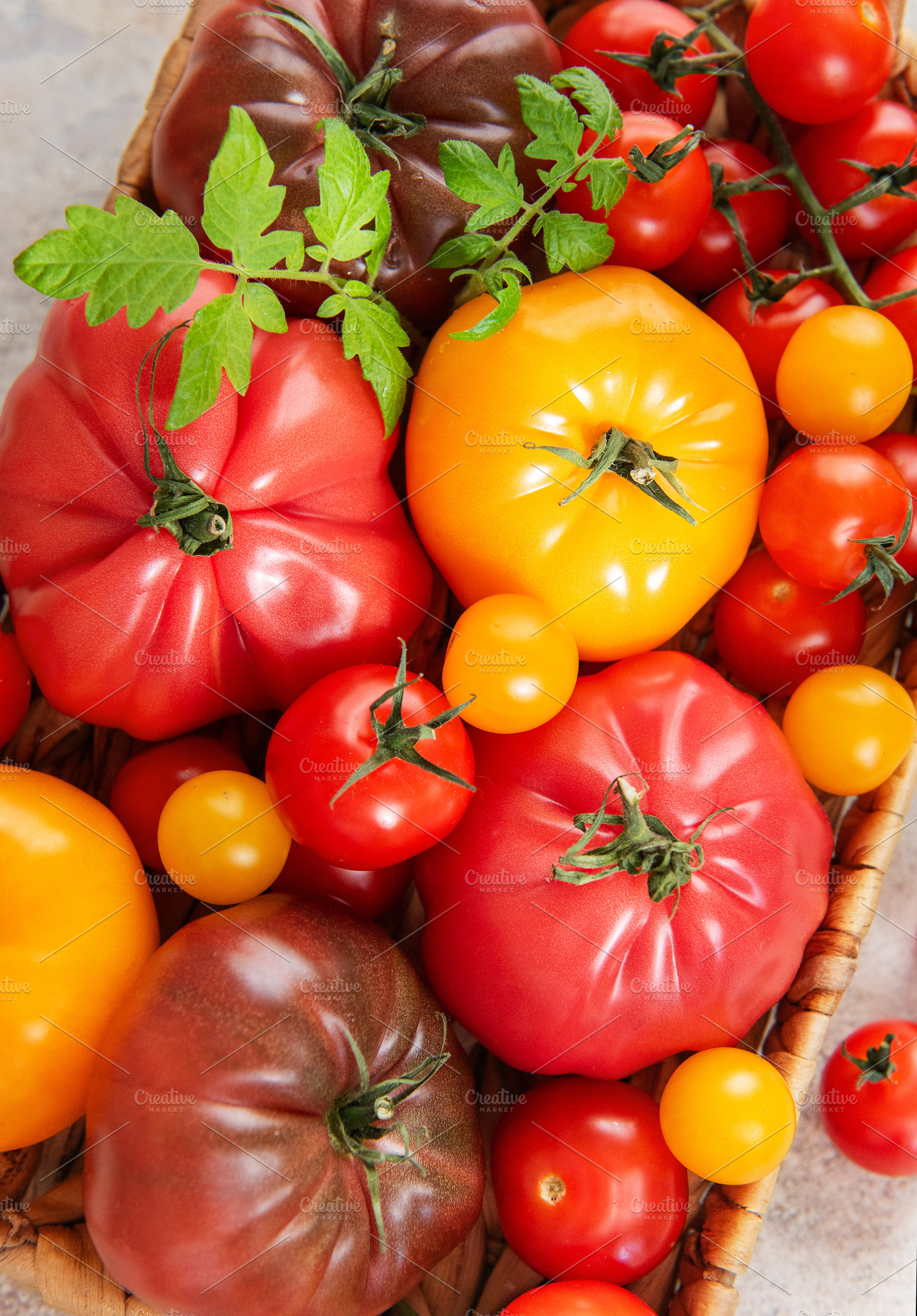 Colorful heirloom tomatoes and cherry tomatoes basket harvest, a Food & Drink Photo by Olena Rudo
