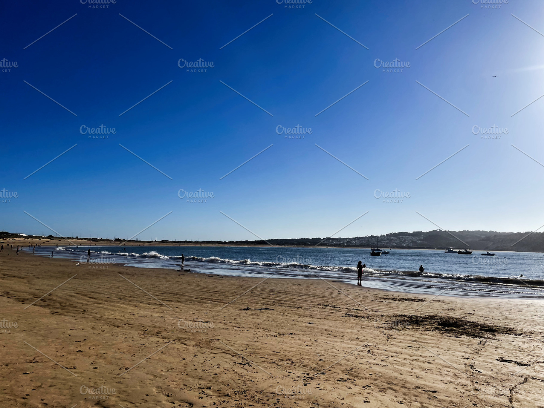 Bright beach day in Cascais Portugal under clear sunny skies, a Photo by AS photostudio