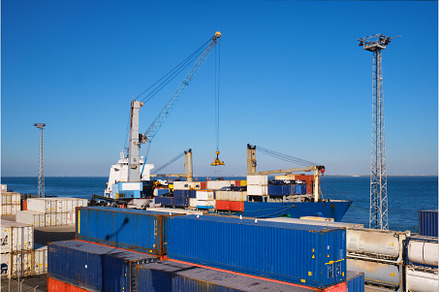 Port crane loading container ship, a Transportation Photo by f9photos