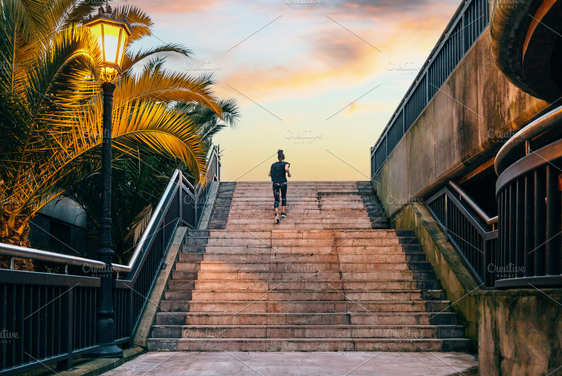 Female runner training up stairs over in urban runway on sunset, a Sports & Recreation Photo by davidpereiras