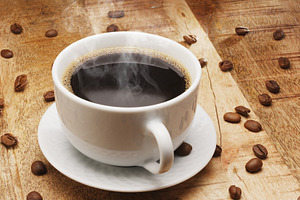 White cup of hot steaming coffee on a wooden table and roasted c, a Food & Drink Photo by Volff