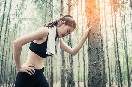 Asian beauty woman tiring from jogging in forest. Lean on tree., a Sports & Recreation Photo by Ministocker