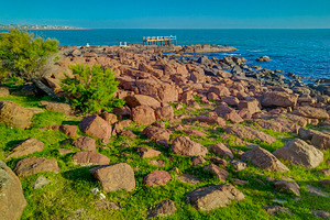 Rugged and rocky coastline on a clear day, a Nature Photo by DanFLCreativo