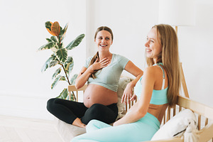 Friends pregnant women in sport wear