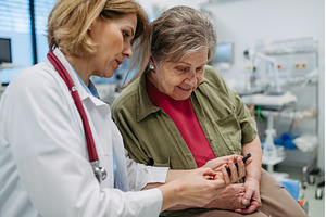Female doctor teaching older patient, a Health & Medical Photo by HalfPoint