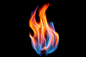 Bright flames dance in vivid colors against a black background, a Photo by AlyaAnd