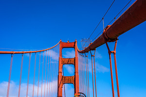 Golden Gate Bridge pedestrian walkway with red cables and blue s, an Architecture Photo by GoodGoods