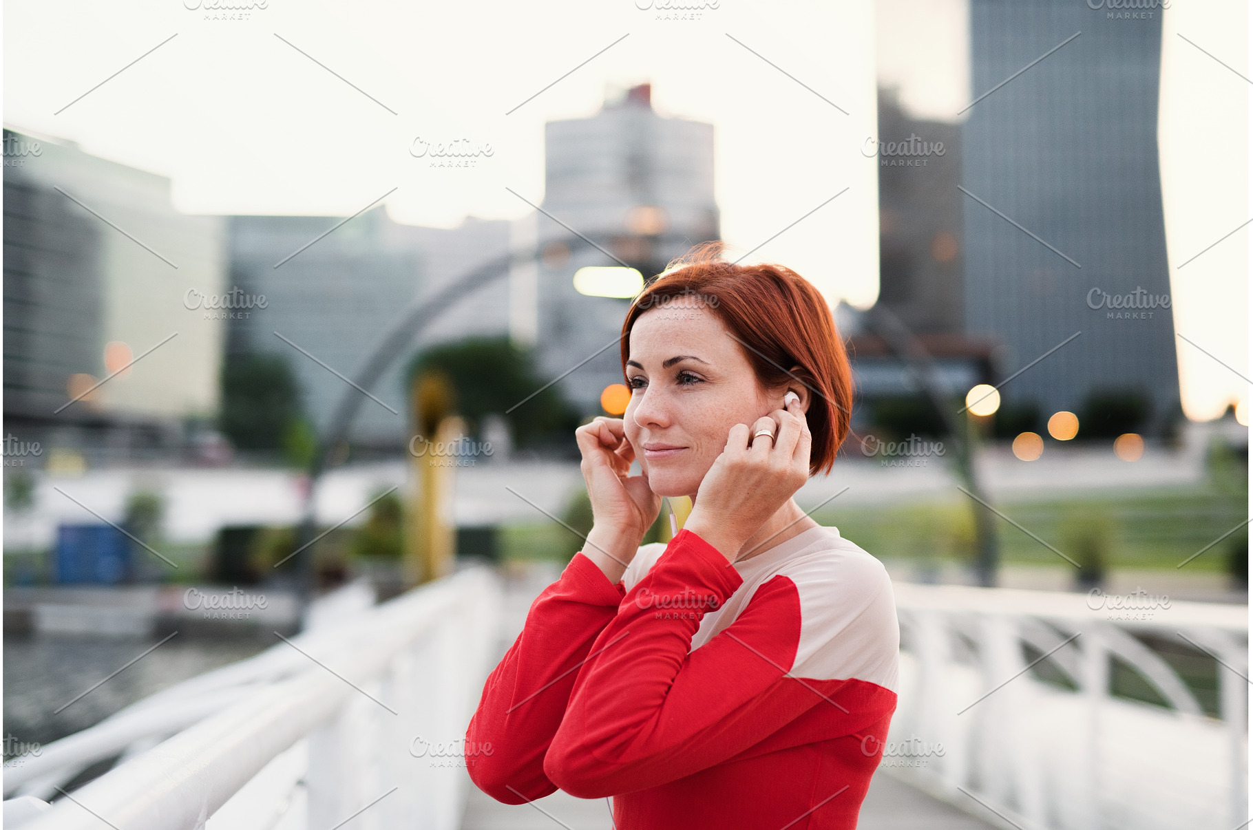 A young woman runner with earphones, a Person Photo by HalfPoint