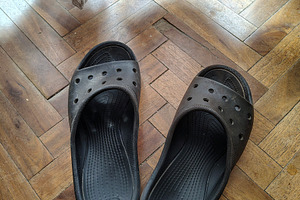 Black worn-out slippers on a wooden parquet floor, a Beauty & Fashion Photo by DanFLCreativo