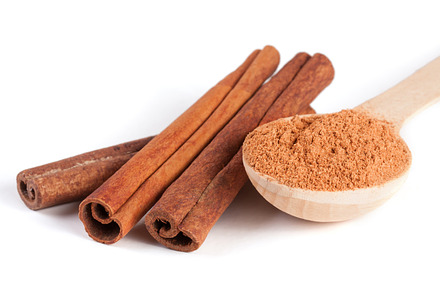 Three cinnamon sticks and powder with spoon isolated on white background, a Food & Drink Photo by NataPhoto