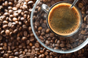 Detail of cup of coffee on glass plate on beans, a Food & Drink Photo by Davizro's Market