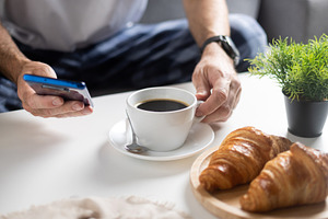 Using Smartphone During Breakfast with Coffee and Croissants, a Food & Drink Photo by etorres69