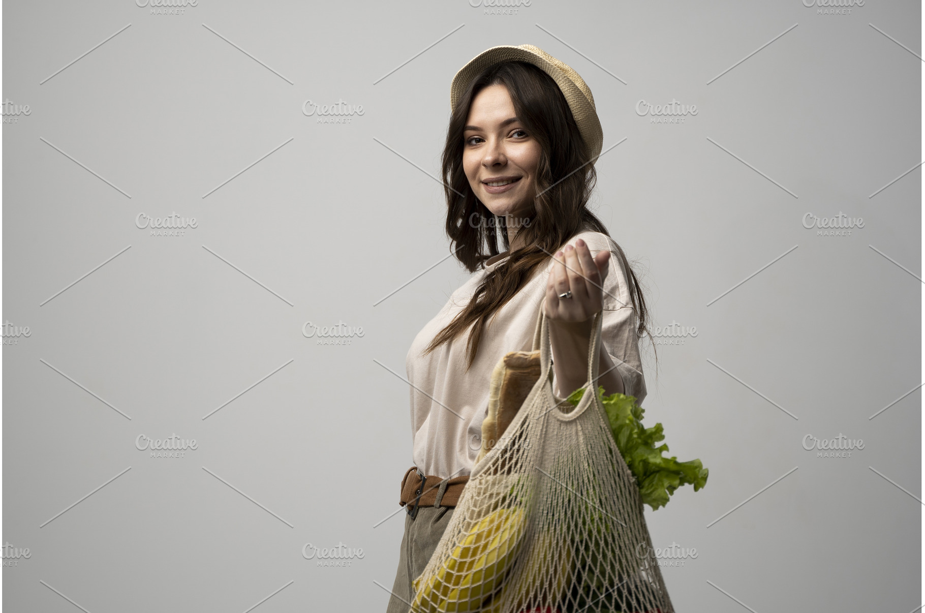 Happy brunette woman carries cotton, a Food & Drink Photo by volodymyrshtun13795