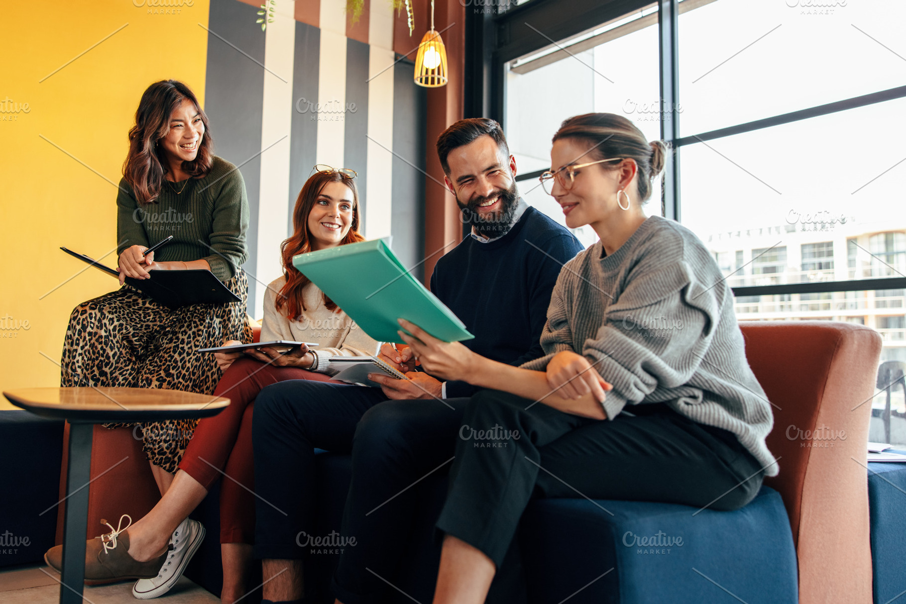 Team of happy businesspeople working in an office lobby, a Person Photo by Jacob Lund
