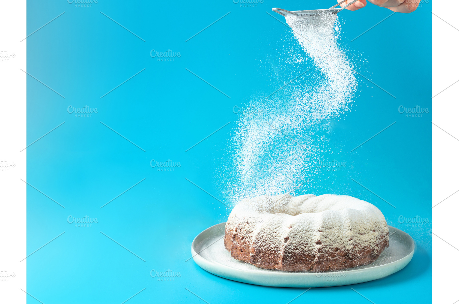 Female hand sprinkling icing sugar, a Food & Drink Photo by Fascinadora
