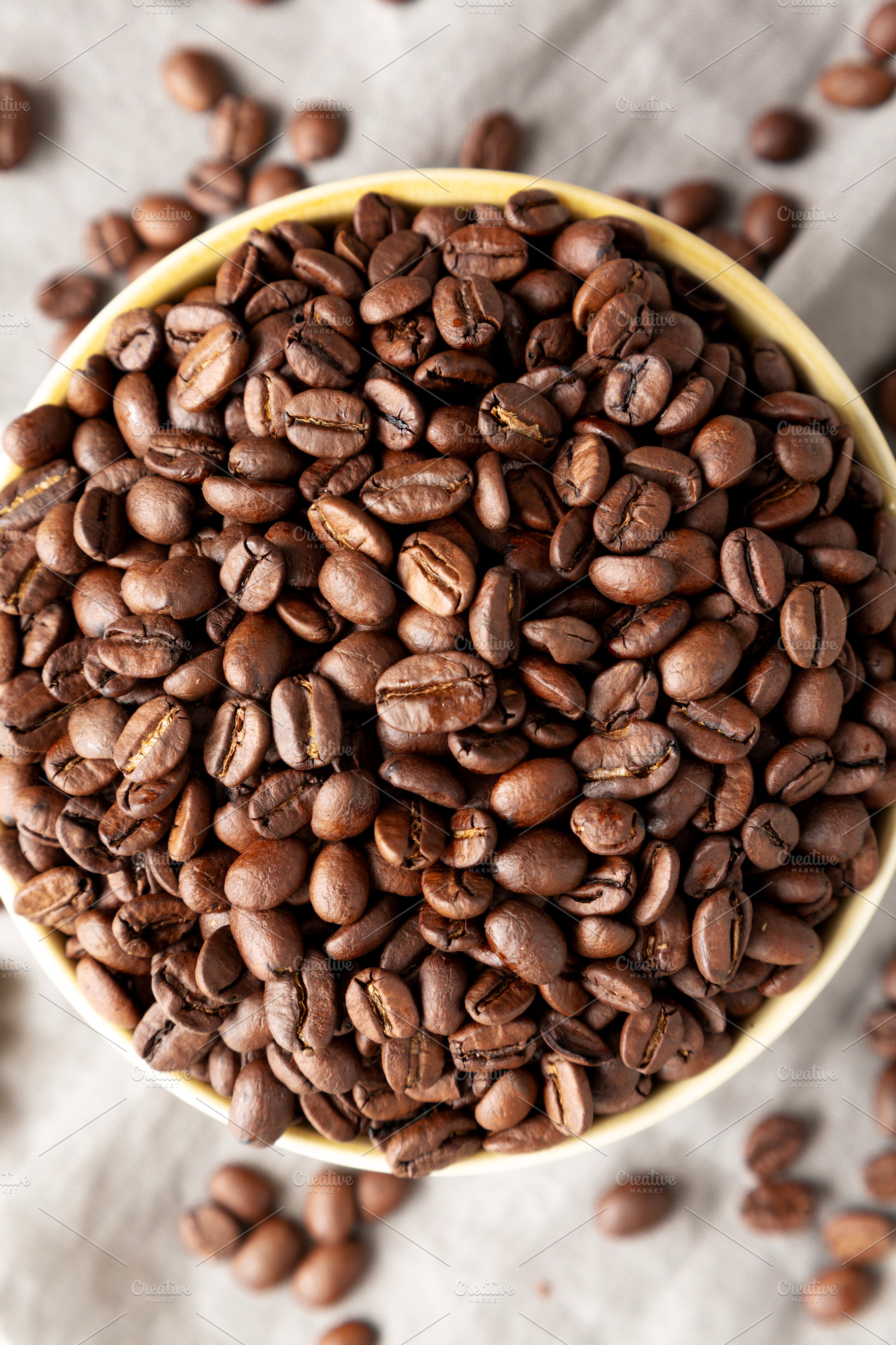 Organic Roasted Coffee Beans in a Bowl, top view., a Food & Drink Photo by LiudmylaChuhunova