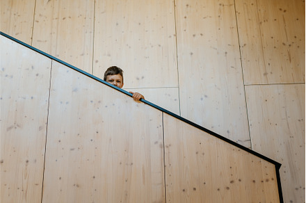 Little boy standing at design wooden, a Person Photo by HalfPoint