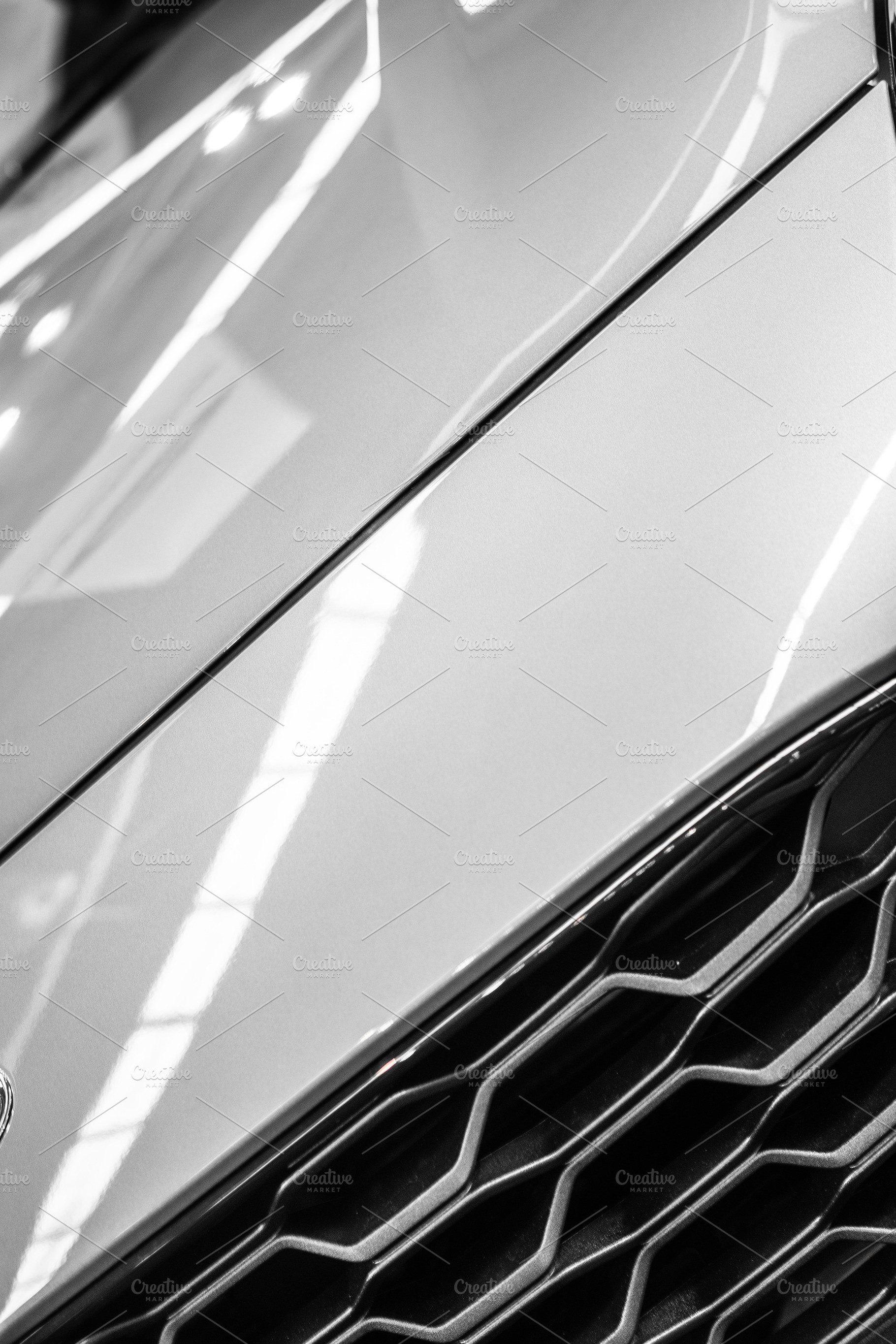 Detail of a grid and shiny metal with engravings, an Abstract Photo by rubenchase