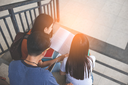 Group of Asian college student using tablet and mobile phone out, a Person Photo by Ministocker