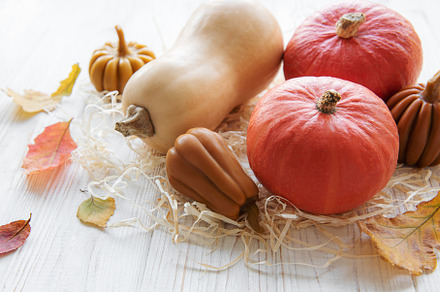 Autumn decorative pumpkins with fall leaves on wooden background, a Food & Drink Photo by Olena Rudo