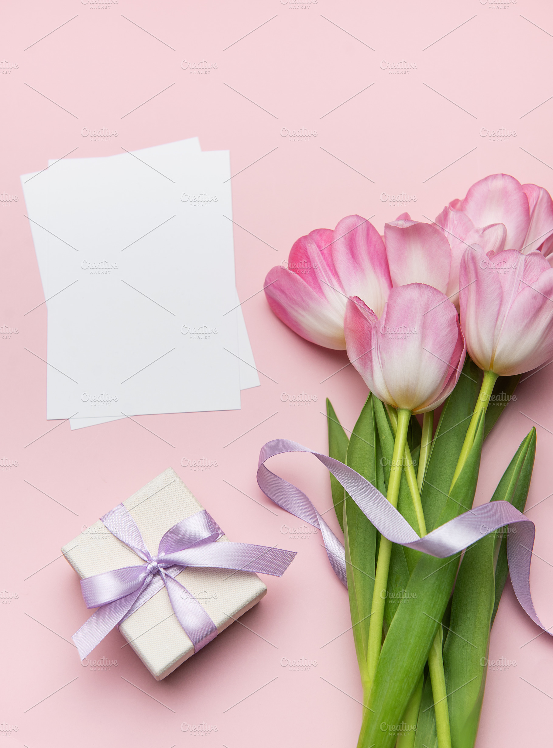 Pink tulips, gift box and blank cards creating a festive flatlay, a Holiday Photo by Olena Rudo
