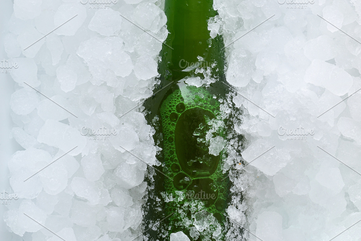Green beer bottle buried in a pile of ice cubes, a Food & Drink Photo by Davizro's Market (Photo 1 of 2)