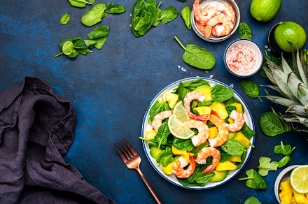 Shrimp pineapple salad with spinach, avocado and lime on blue ki, a Food & Drink Photo by 5PH