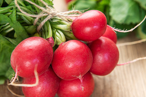 Fresh organic radishes with green leaves on wooden table, a Food & Drink Photo by Olena Rudo