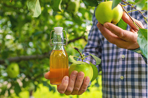 Apple cider vinegar against a, a Food & Drink Photo by yanadjana