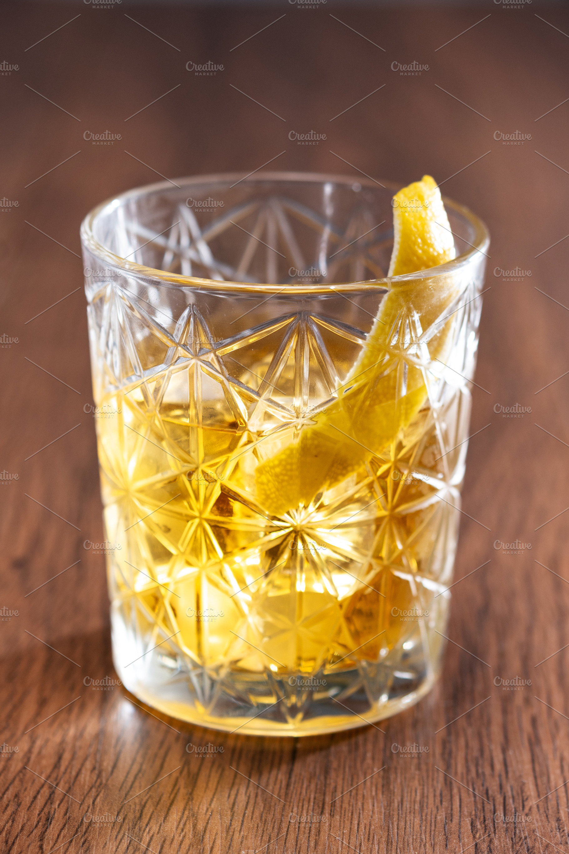 Rusty Nail Cocktail with Lemon Peel in Crystal Glass, a Food & Drink Photo by etorres69