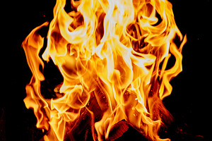 Close-up of tall bright flames, tongues of fire and orange-yello, a Background Photo by ndanko
