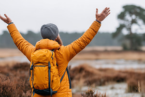 Man in yellow jacket with backpack, a Person Photo by MistyDay