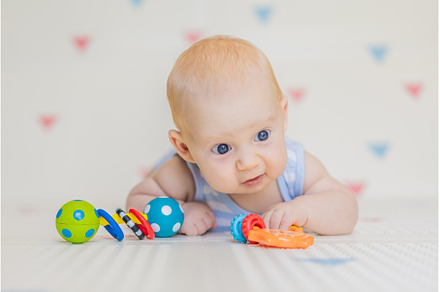 Adorable baby playing with colorful