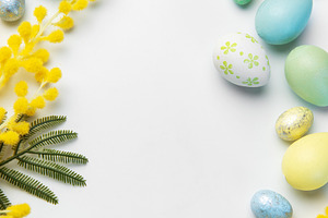 Easter eggs and mimosa flowers creating spring frame, a Holiday Photo by Olena Rudo