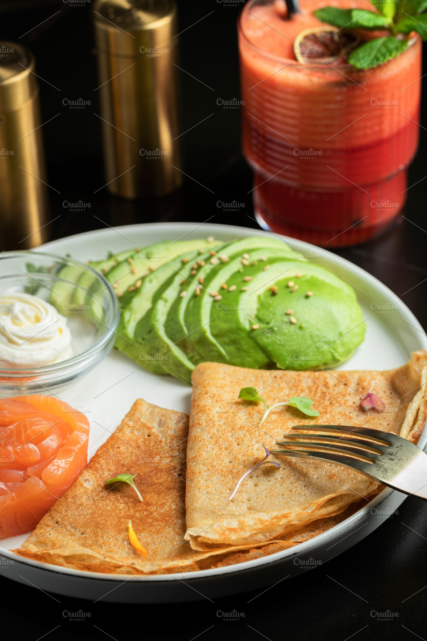 Roasted thin pancakes with smoked salmon and sauce, a Food & Drink Photo by Budarinphoto