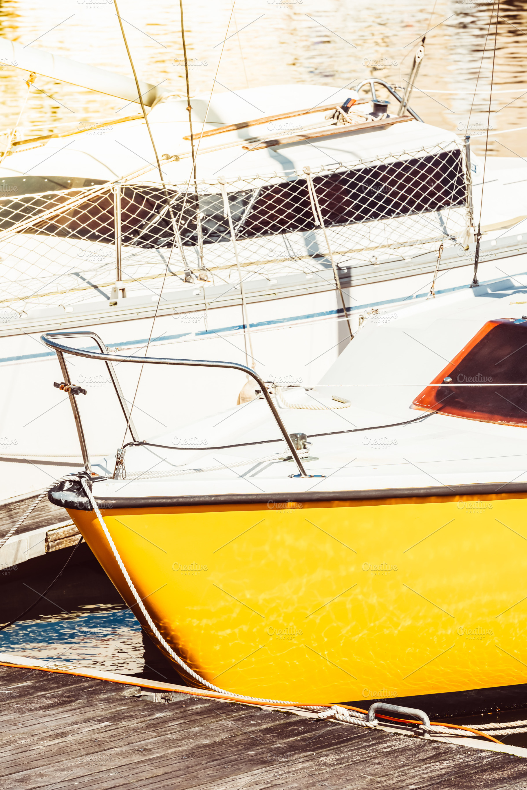 Sailboats moored in sunny marina wit, a Photo by Dvoevnore photos