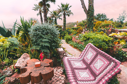 Garden bench with crochet blanket