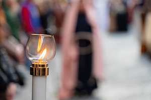 Burning candle illuminating good friday procession in Italy, a Holiday Photo by Antonio Gravante Market