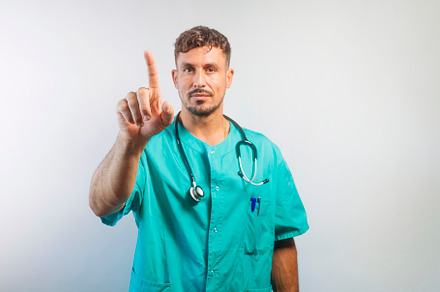 Doctor Pointing Upwards with Finger