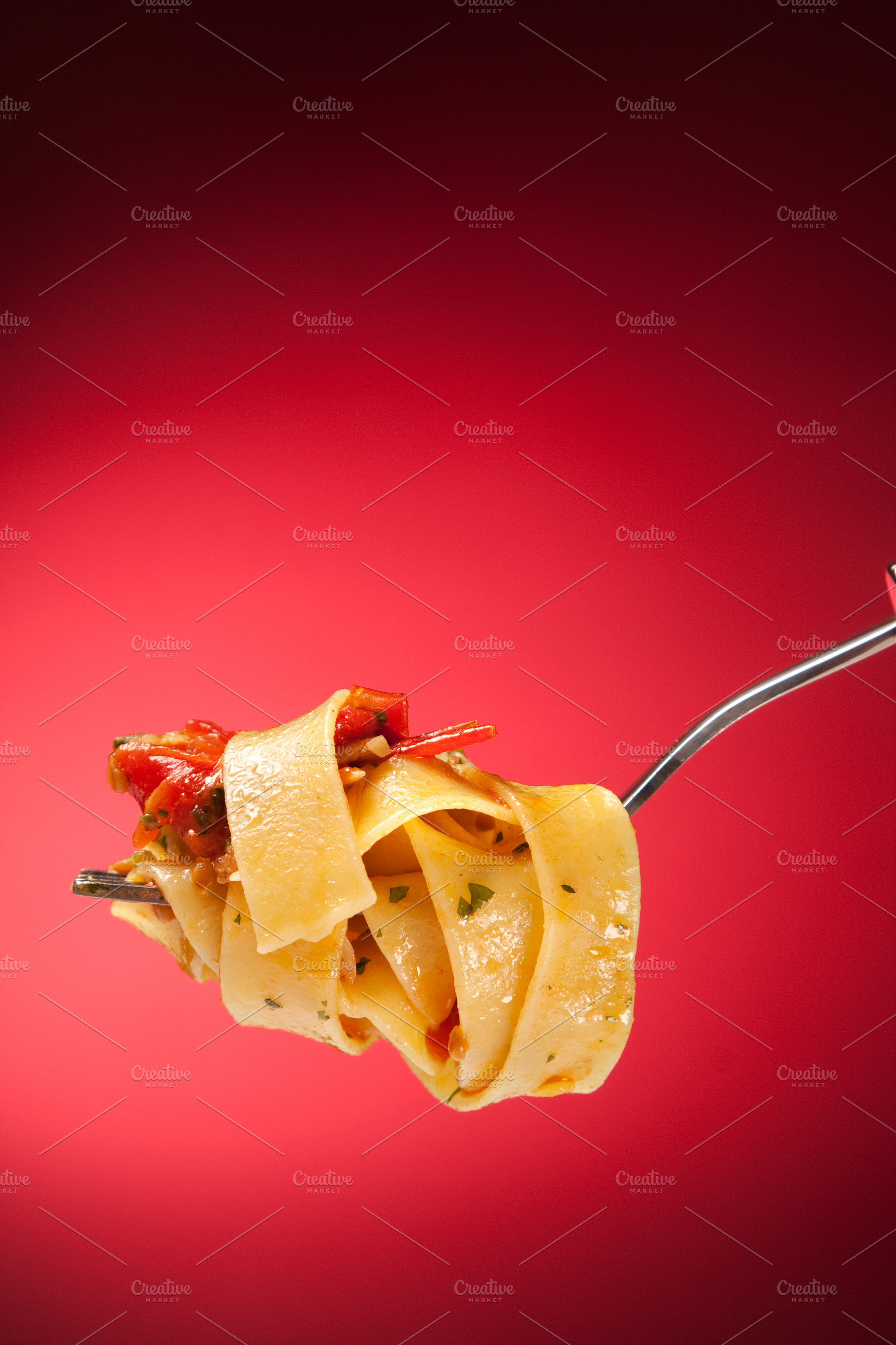 Tagliatelle with clams on a red background, a Food & Drink Photo by FoodStock