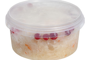 Sauerkraut with cranberries in a plastic container on an isolate, a Food & Drink Photo by ndanko