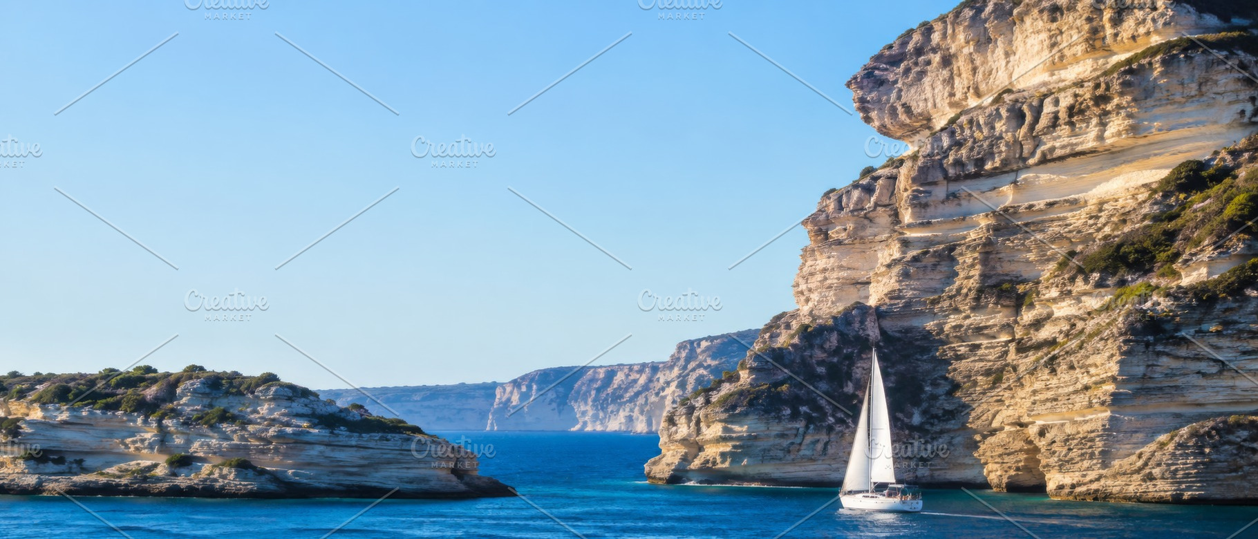 Sailboat navigating between rocky cl, a Photo by Dvoevnore photos