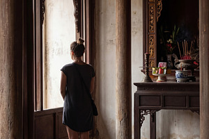 Woman Looking Out Temple Window, a Person Photo by Virgo Studio