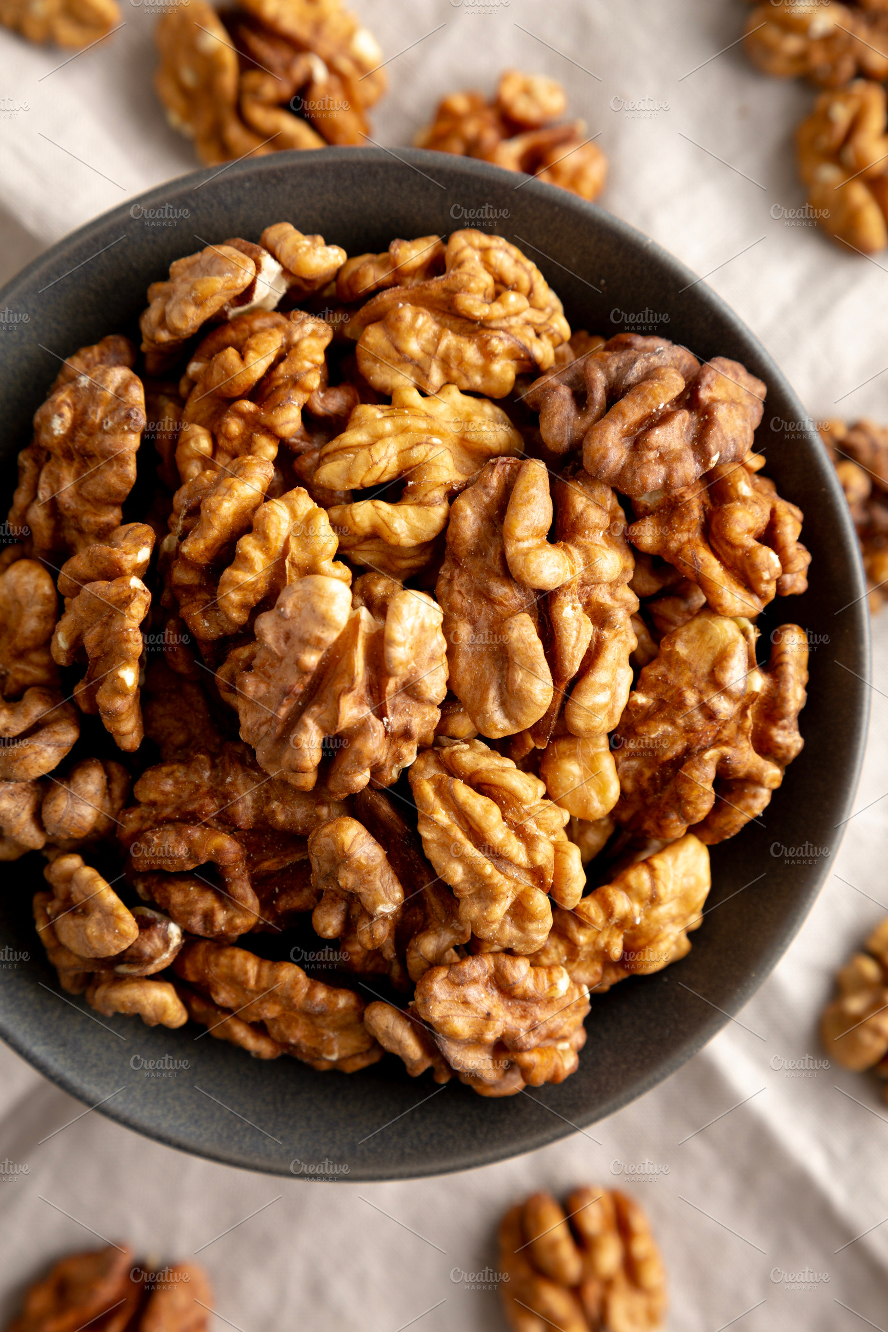 Raw Walnut Halfs in a Bowl, top view. Flat lay, overhead. Close-, a Food & Drink Photo by LiudmylaChuhunova